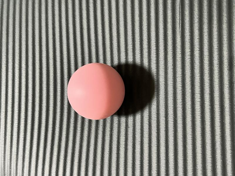 マットの上に置いたピンクのラクロスボール